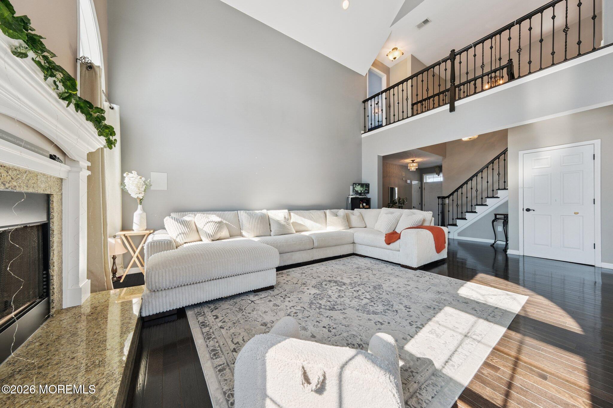8 Patton Court Manalapan, NJ 07726 - Photo 7 of 23 a living room with furniture and a fireplace