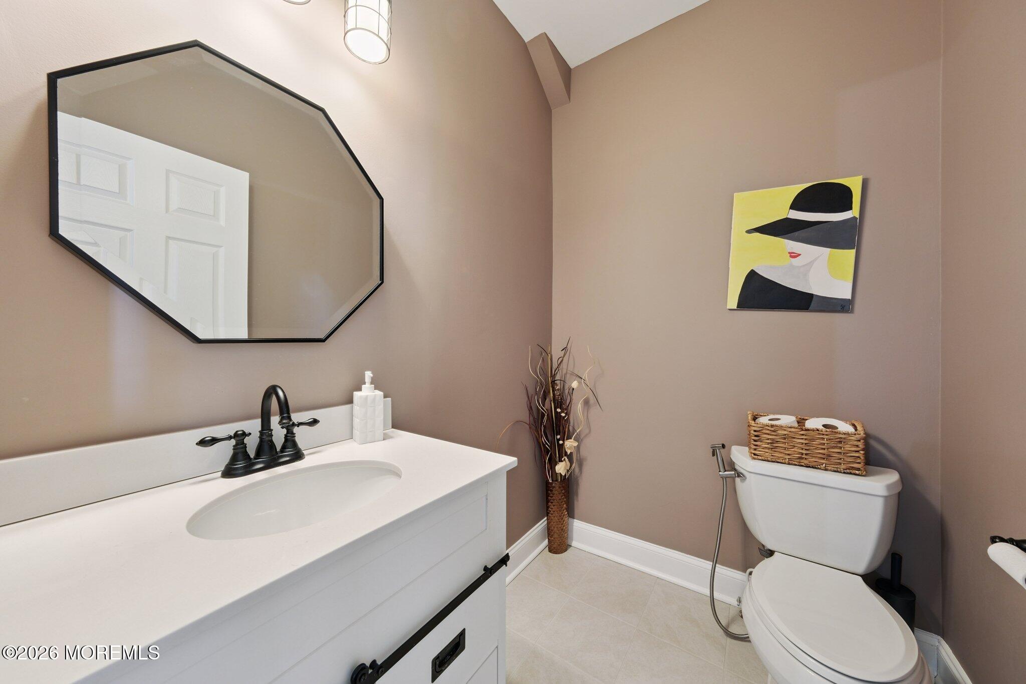 8 Patton Court Manalapan, NJ 07726 - Photo 8 of 23 a bathroom with a toilet sink and mirror