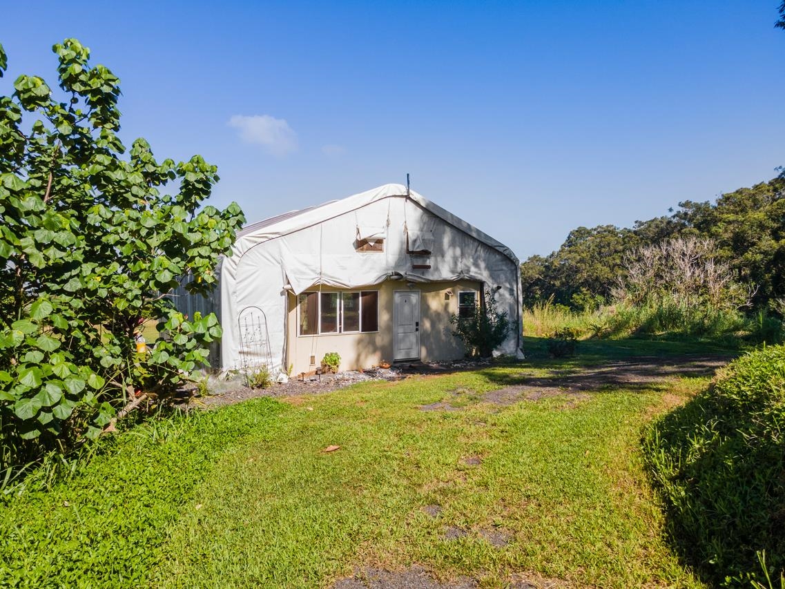 676 Kaupakalua Road, Unit A Haiku, HI 96708 - Photo 15 of 21 a large house with a big yard and large trees