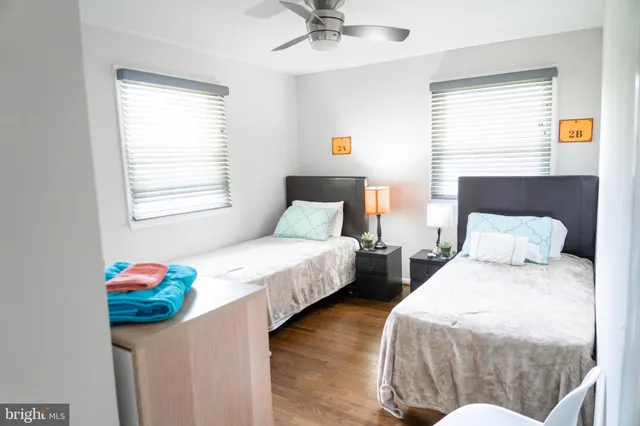 a bedroom with two beds and a chandelier