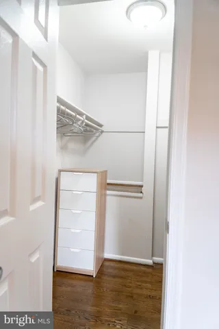 a view of walk in closet with empty racks
