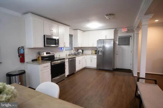 a kitchen with stainless steel appliances a refrigerator sink and microwave