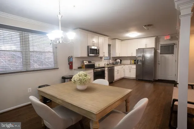 a kitchen with sink refrigerator and microwave