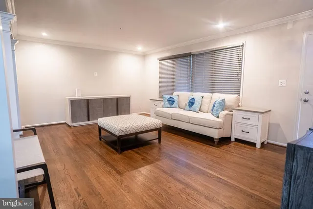a bedroom with furniture and wooden floor