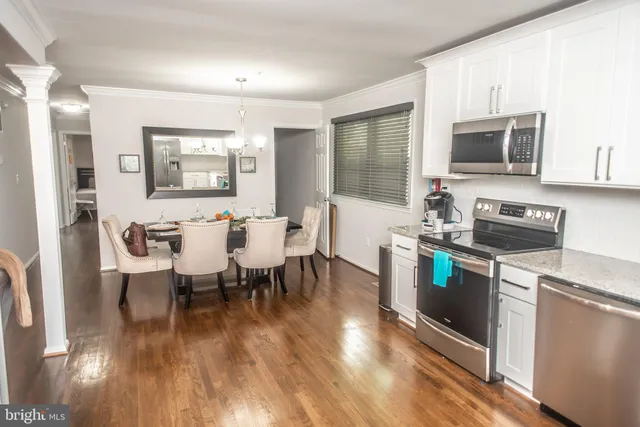 a view of a dining room with furniture and wooden floor