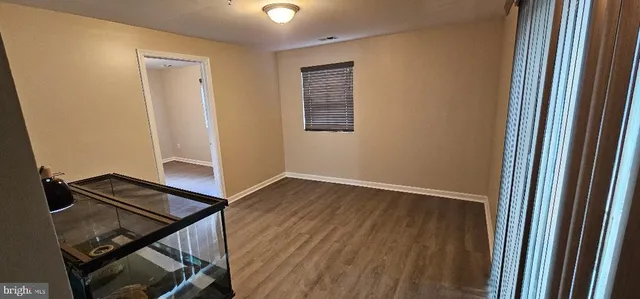 a view of an empty room and wooden floor