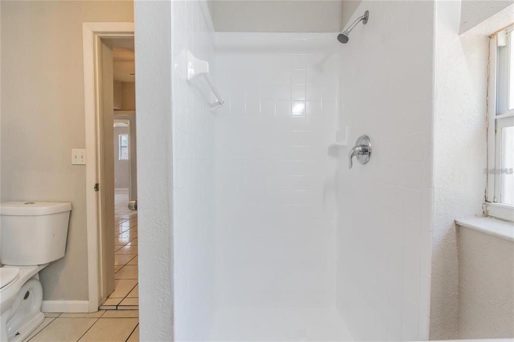 1911 West St Conrad Street Tampa, FL 33607 - Photo 17 of 35 a bathroom with a toilet and a shower