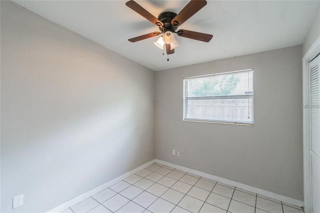 1911 West St Conrad Street Tampa, FL 33607 - Photo 19 of 35 an empty room with windows and ceiling fan