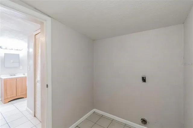 a view of a small yard in front of a house with a large tree
