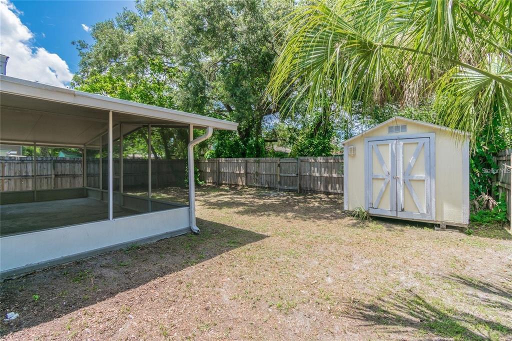 1911 West St Conrad Street Tampa, FL 33607 - Photo 29 of 35 a view of backyard with small cabin and wooden fence
