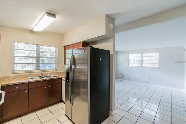 a kitchen with stainless steel appliances granite countertop a refrigerator and a sink