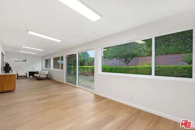 a large bedroom with a large window and a balcony