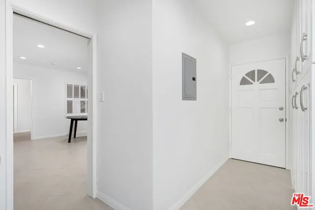 a view of a hallway and a livingroom with wooden floor
