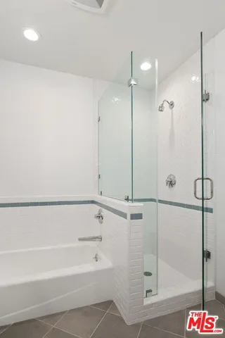 a bathroom with a bathtub and a shower