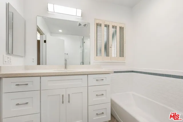 a bathroom with a bathtub and a sink