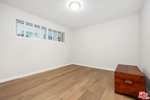 a view of an empty room and wooden floor