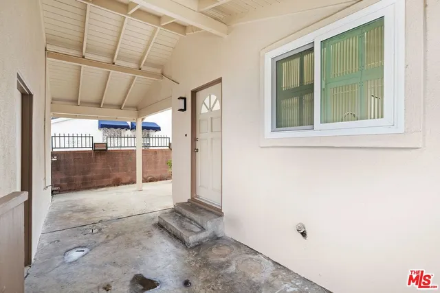 a view of a hallway with wooden door