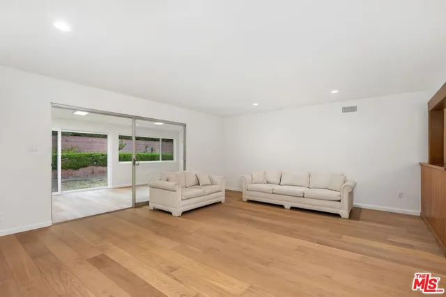 a living room with furniture and white walls
