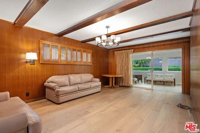 a living room with furniture and a floor to ceiling window