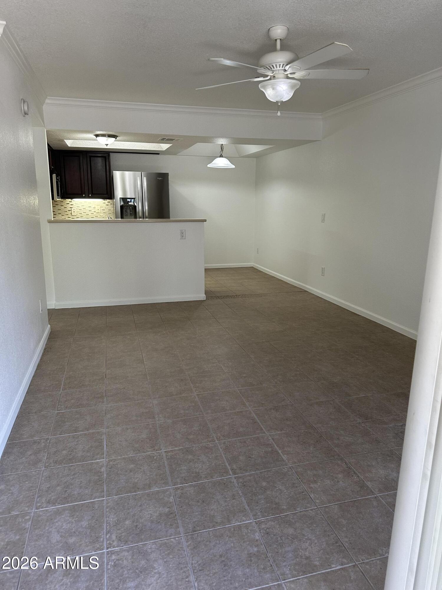 1720 East Thunderbird Road, Unit 1019 Phoenix, AZ 85022 - Photo 23 of 47 an empty room with kitchen and chandelier fan