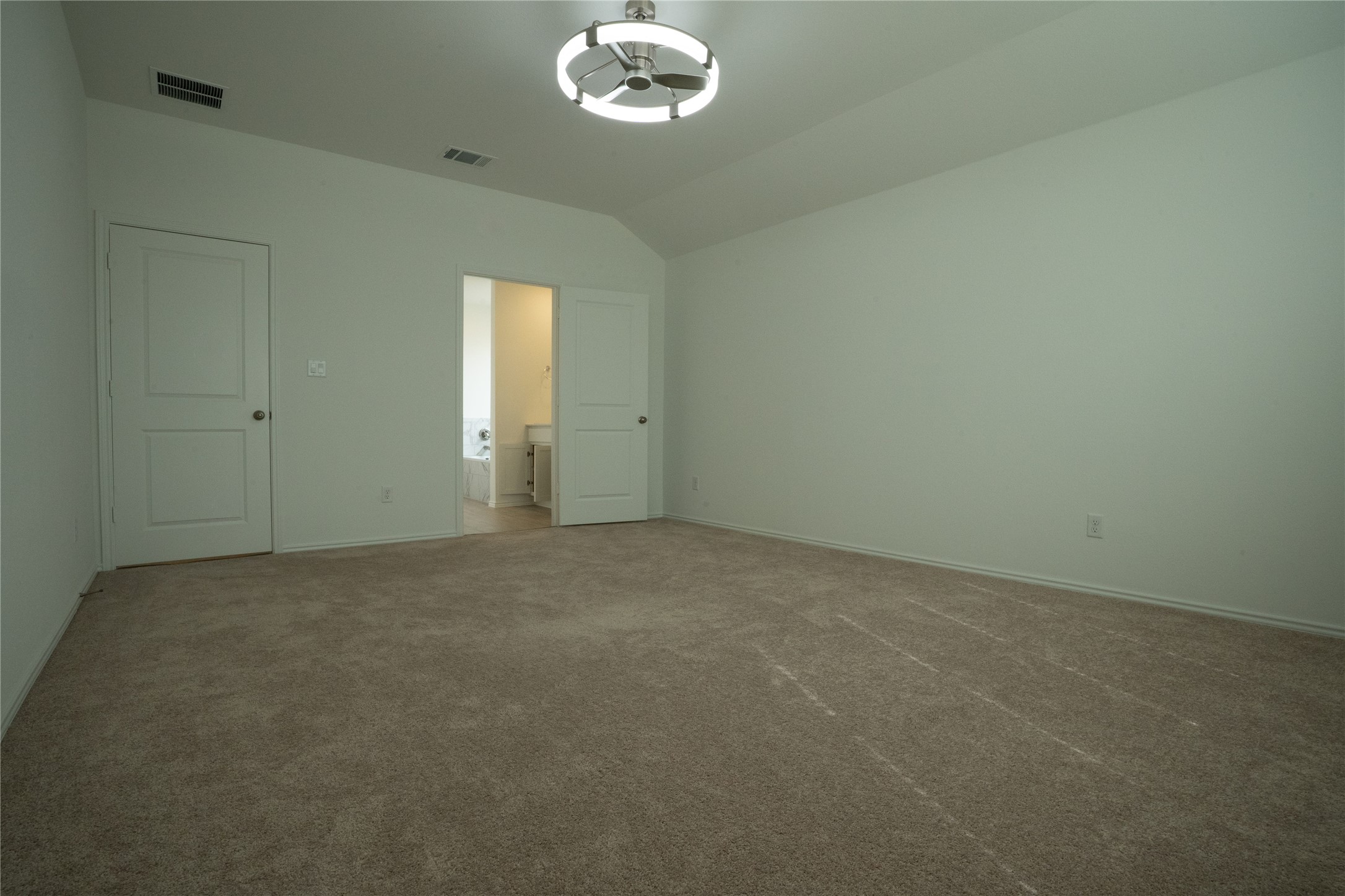 105 Carmello Kyle, TX 78640 - Photo 8 of 30 Unfurnished bedroom featuring carpet floors and vaulted ceiling