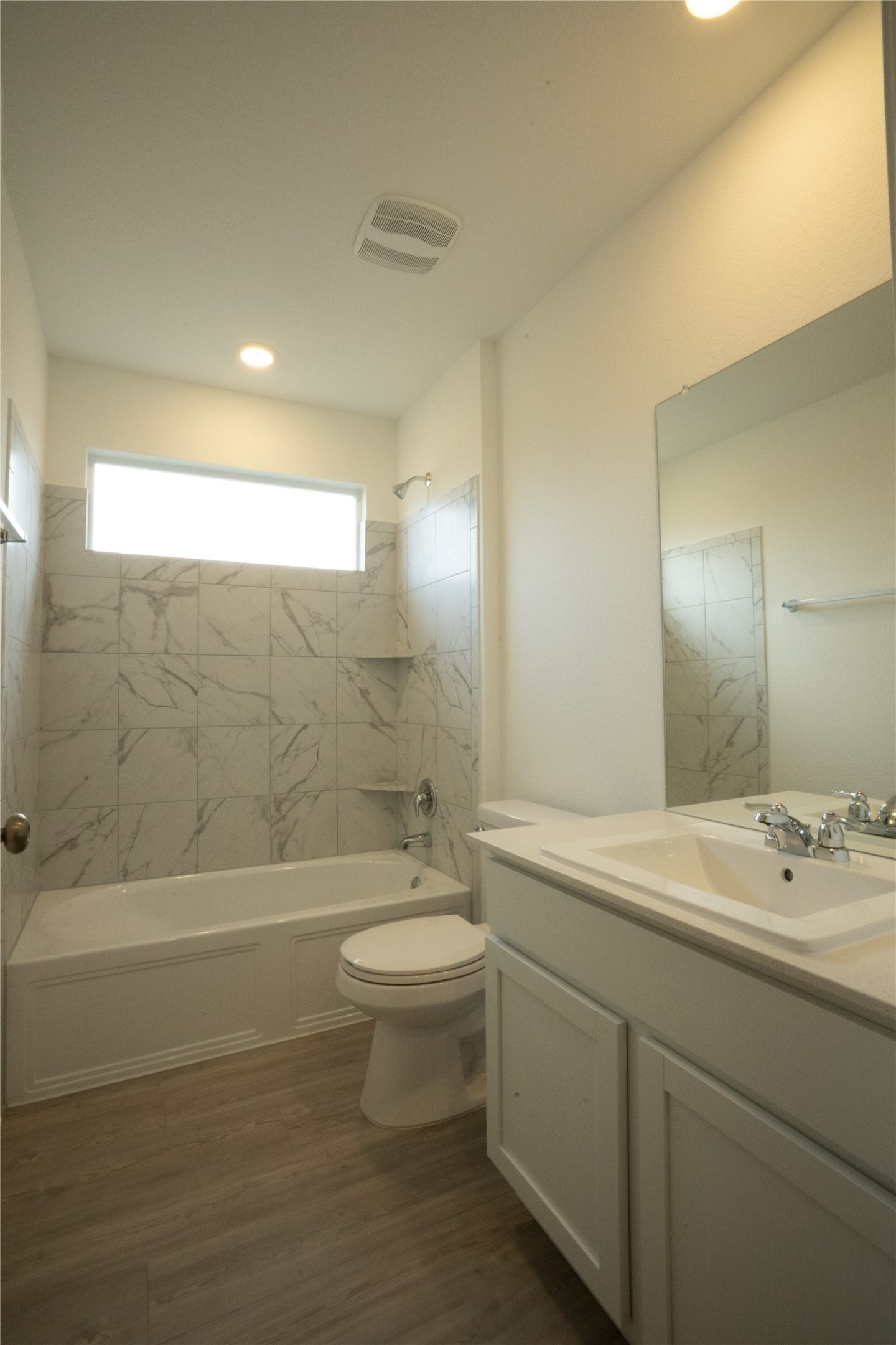 105 Carmello Kyle, TX 78640 - Photo 16 of 30 Full bathroom featuring shower combination, vanity, dark wood-style floors, and recessed lighting