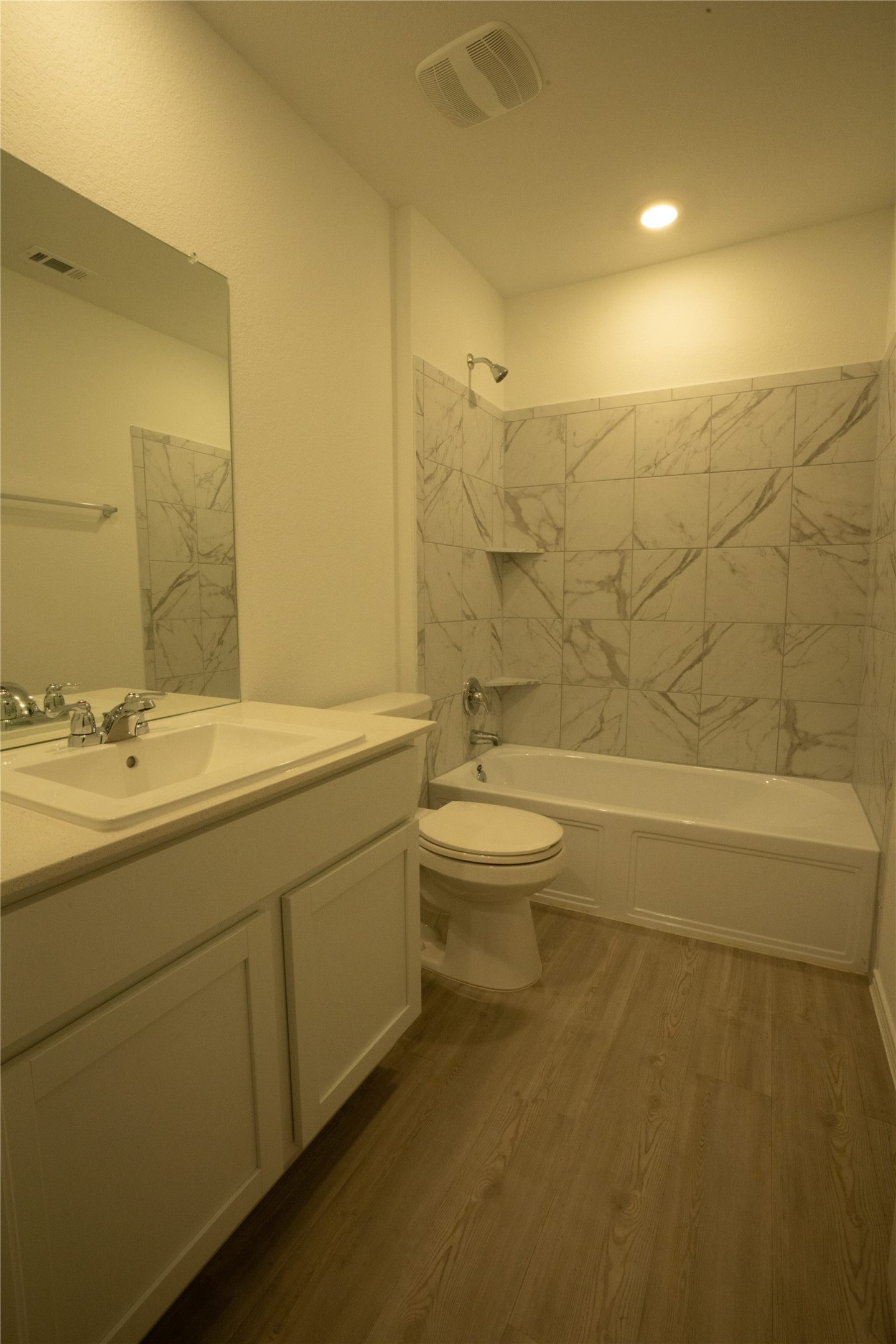 105 Carmello Kyle, TX 78640 - Photo 20 of 30 Full bath featuring bathing tub / shower combination, vanity, and light wood-style floors