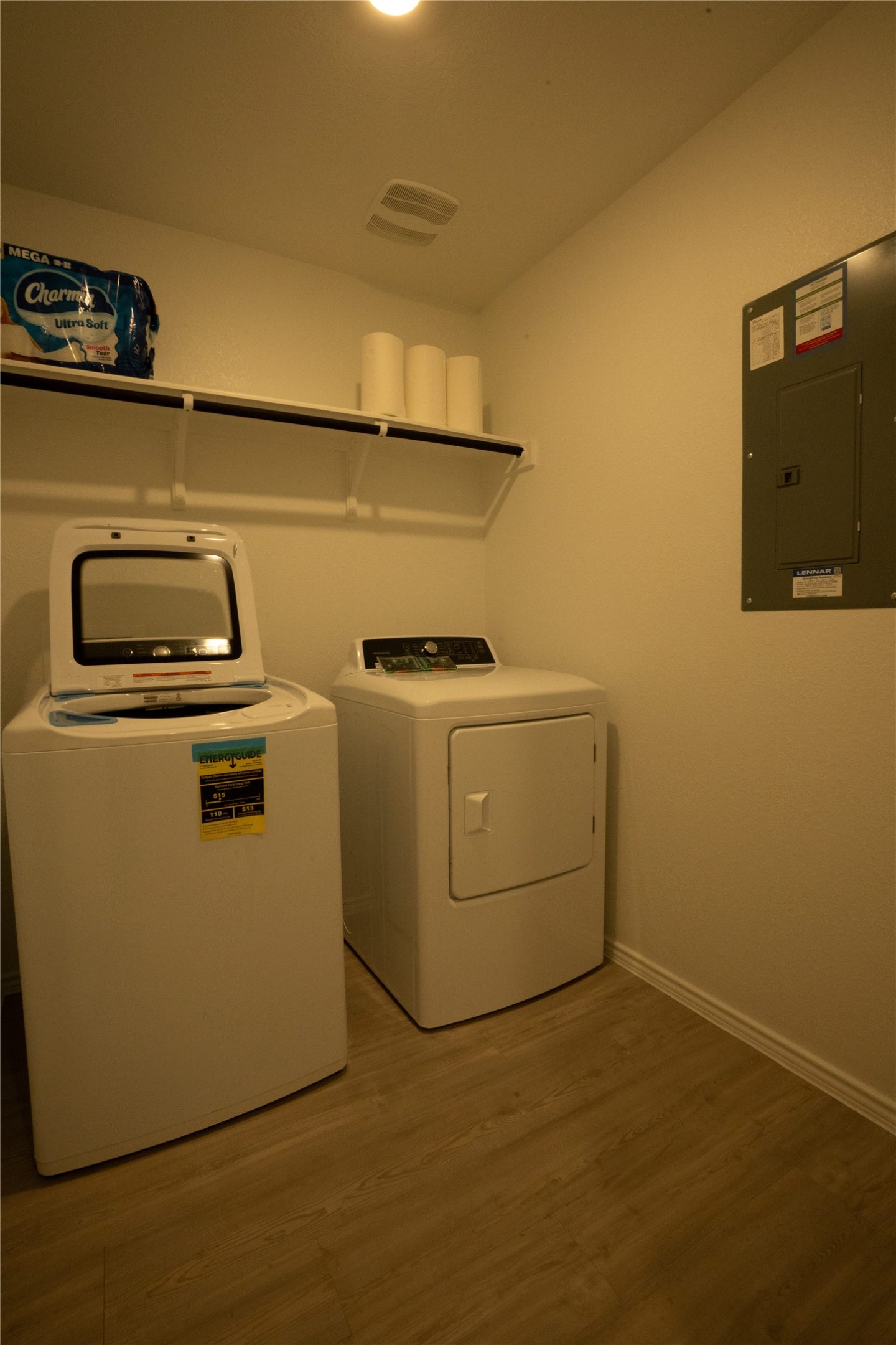 105 Carmello Kyle, TX 78640 - Photo 23 of 30 Laundry room with light wood-style flooring, electric panel, and washer and dryer