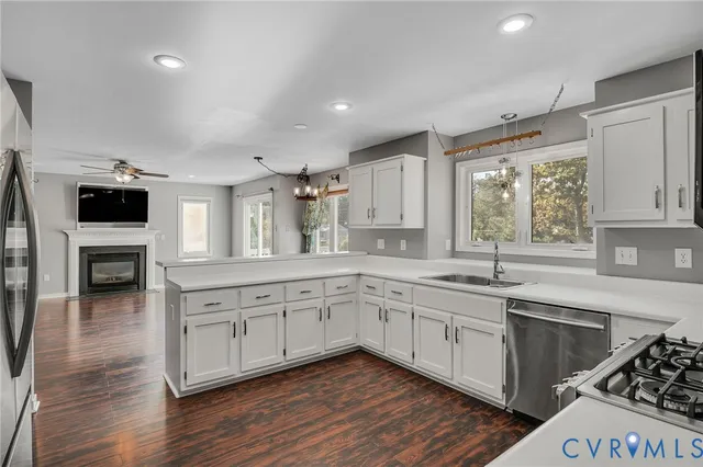 a large kitchen with stainless steel appliances granite countertop a stove and a sink