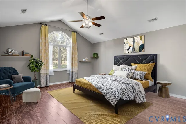 a bedroom with a bed couch and a window