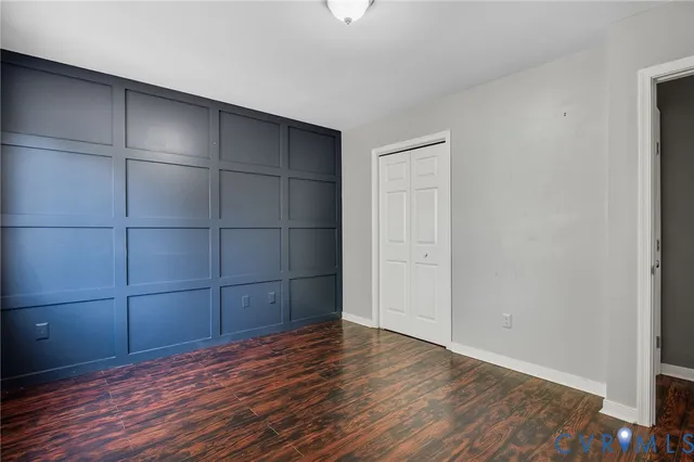 a view of a room with wooden floor