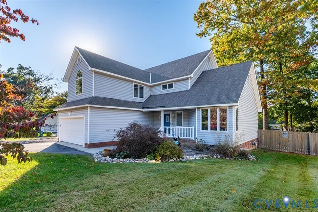a front view of a house with a garden and yard