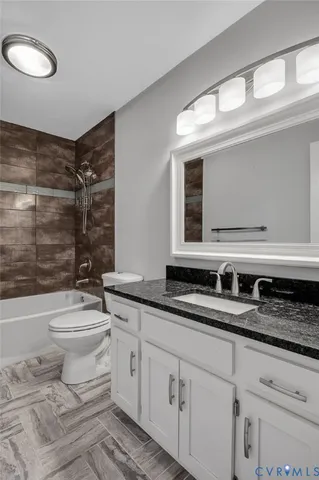 a bathroom with a double vanity sink mirror and toilet