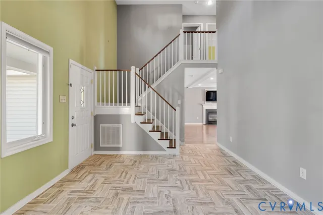 a view of entryway and hall with wooden floor