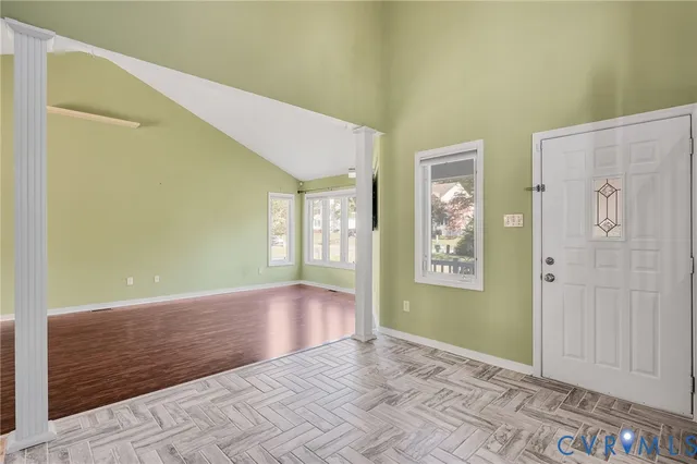 a view of an empty room with window and bathroom