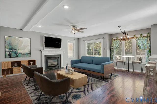 a living room with furniture a fireplace and a flat screen tv