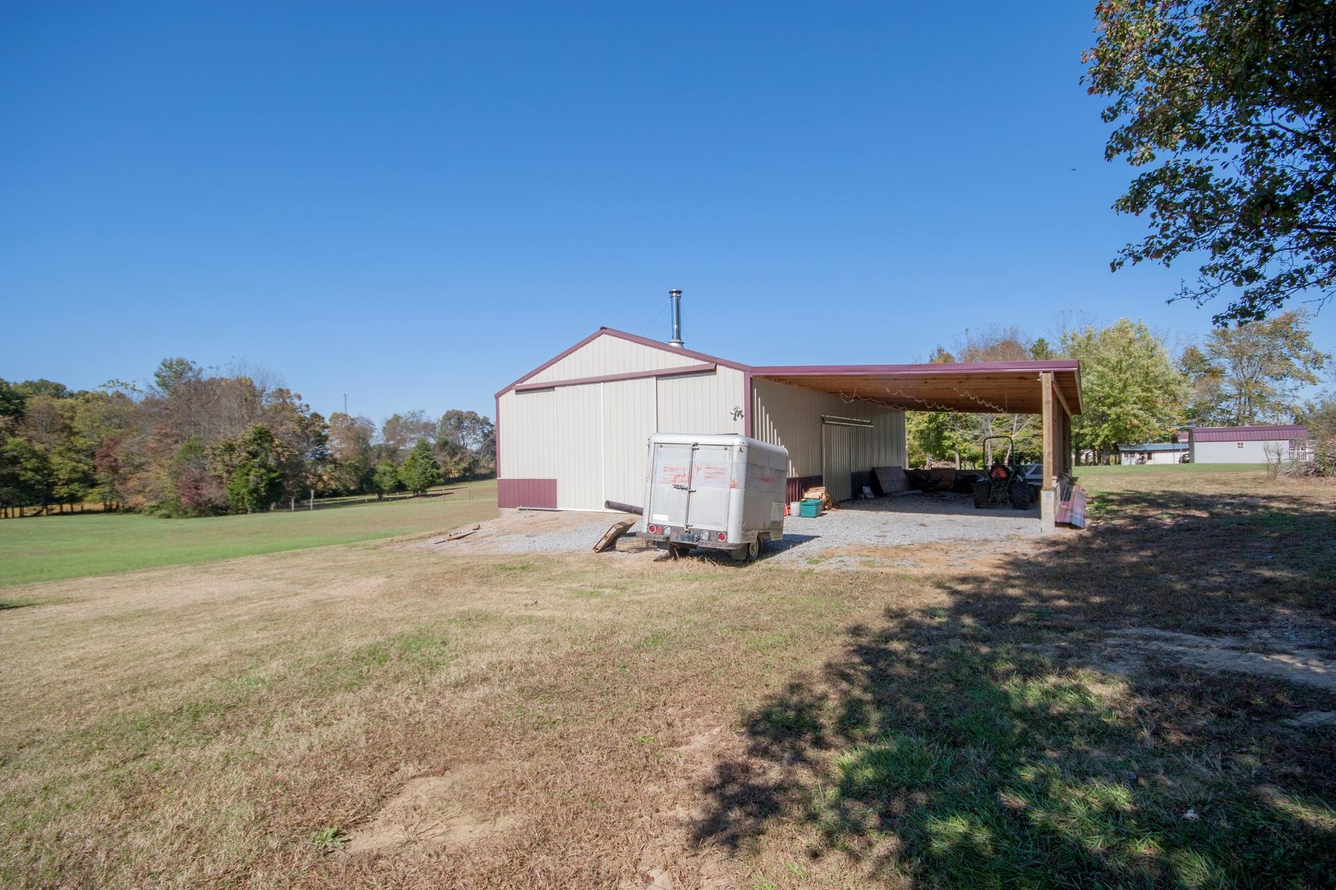 180 Dorris Road Portland, TN 37148 - Photo 16 of 19 a view of a house with backyard and trees