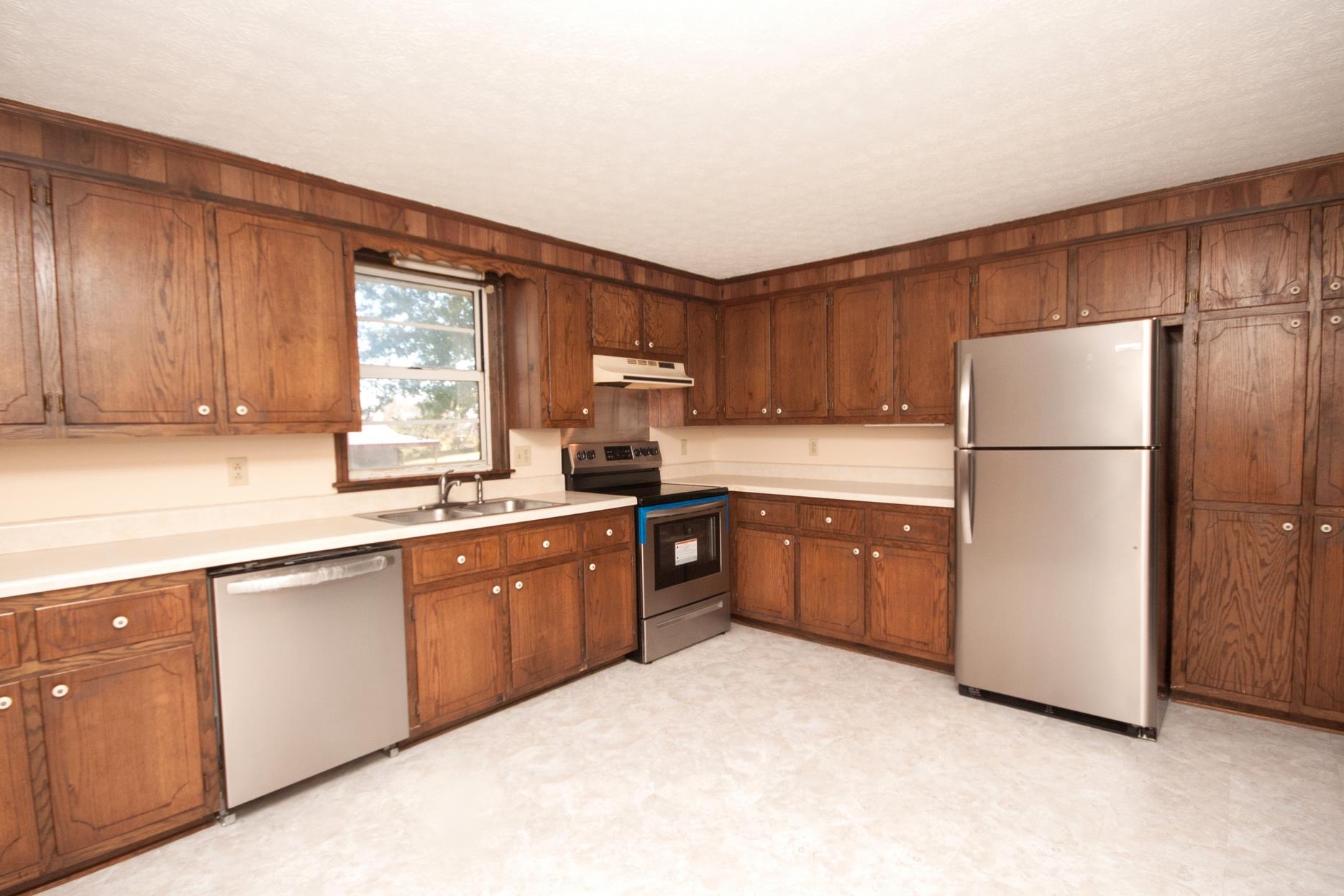 180 Dorris Road Portland, TN 37148 - Photo 8 of 19 a kitchen with sink a window and stainless steel appliances