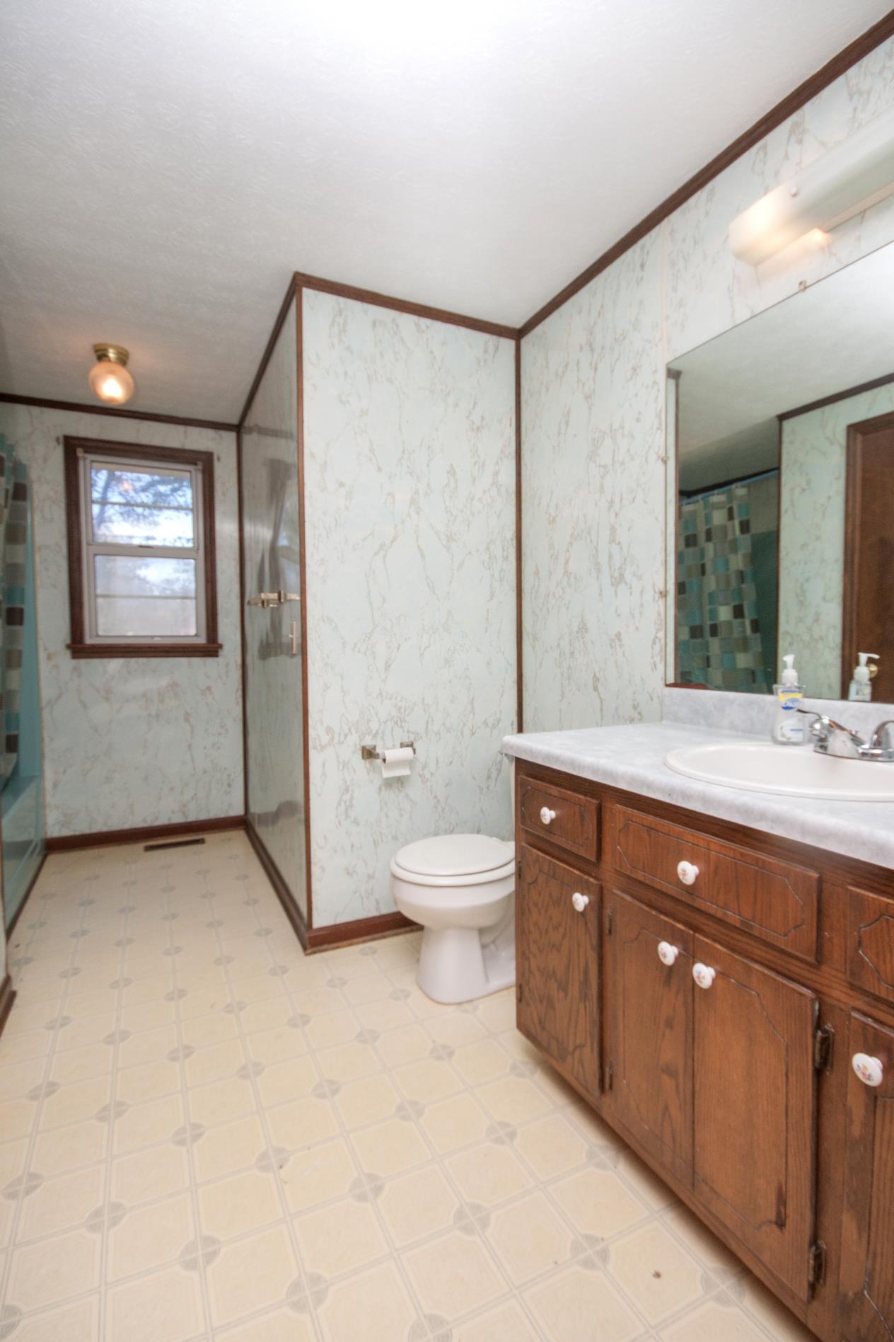 180 Dorris Road Portland, TN 37148 - Photo 10 of 19 a spacious bathroom with a toilet a sink and mirror