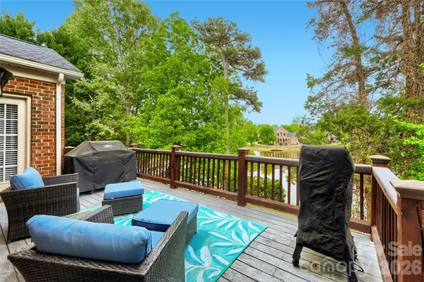a view of a patio with couches chairs and wooden floor