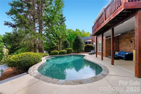 a view of a house with swimming pool and sitting area