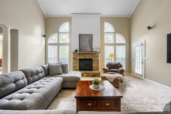 a living room with furniture fireplace and a large window