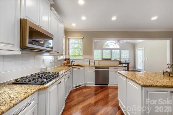a kitchen with a stove a sink and a microwave