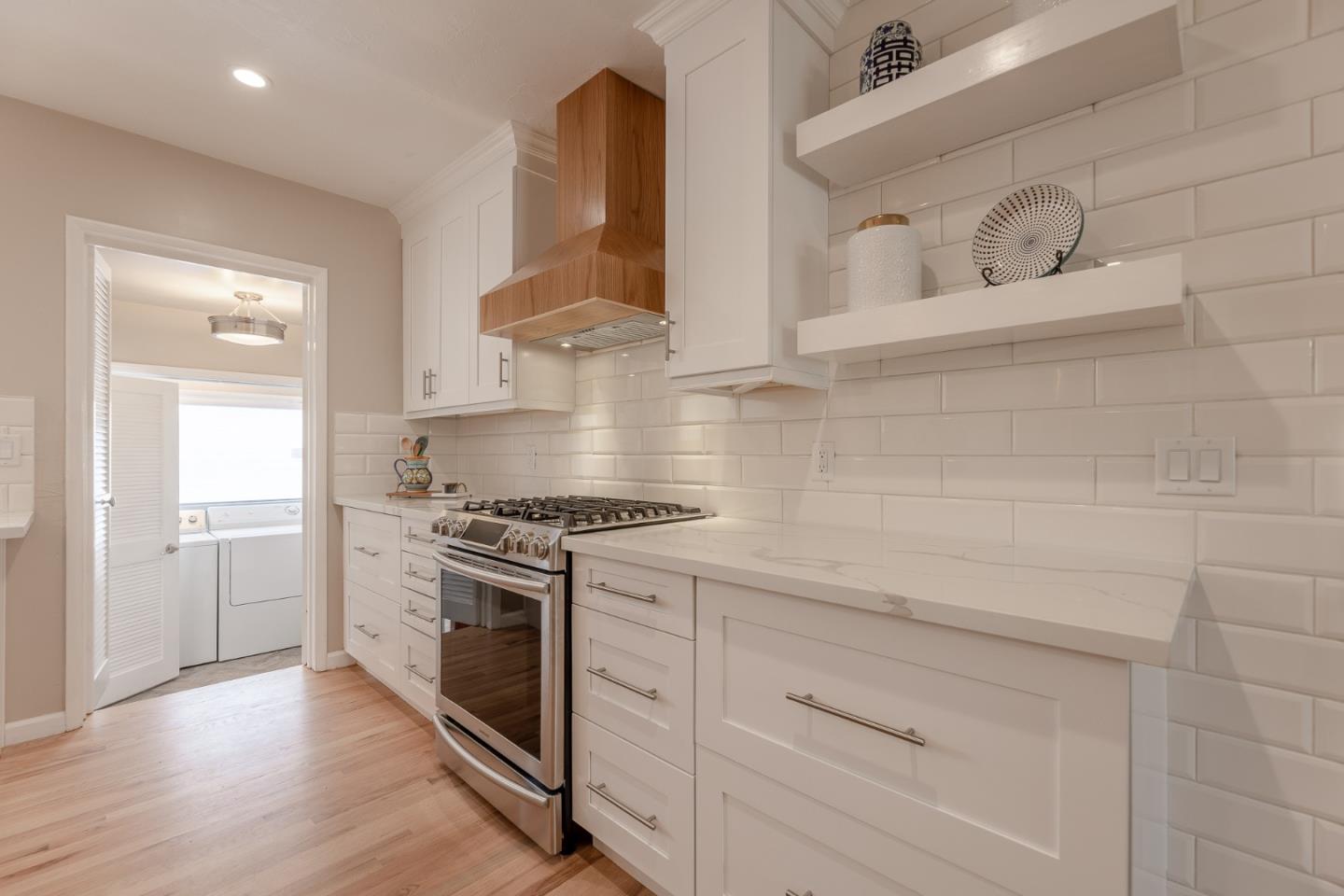 1130 Ripple Avenue Pacific Grove, CA 93950 - Photo 12 of 38 a kitchen with white cabinets and a stove