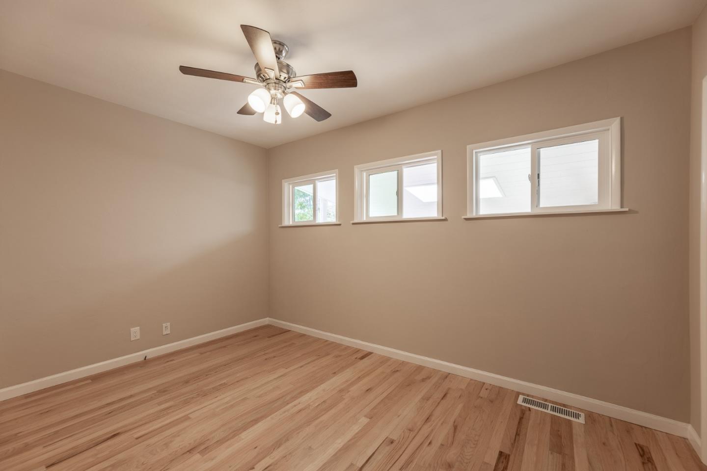 1130 Ripple Avenue Pacific Grove, CA 93950 - Photo 17 of 38 a view of an empty room with wooden floor and a window