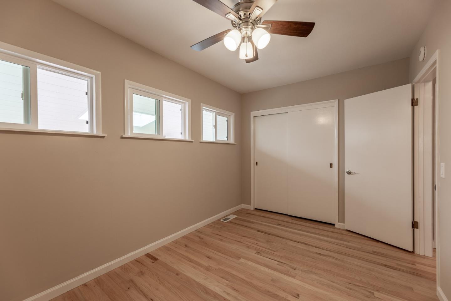 1130 Ripple Avenue Pacific Grove, CA 93950 - Photo 18 of 38 a view of empty room with wooden floor and fan