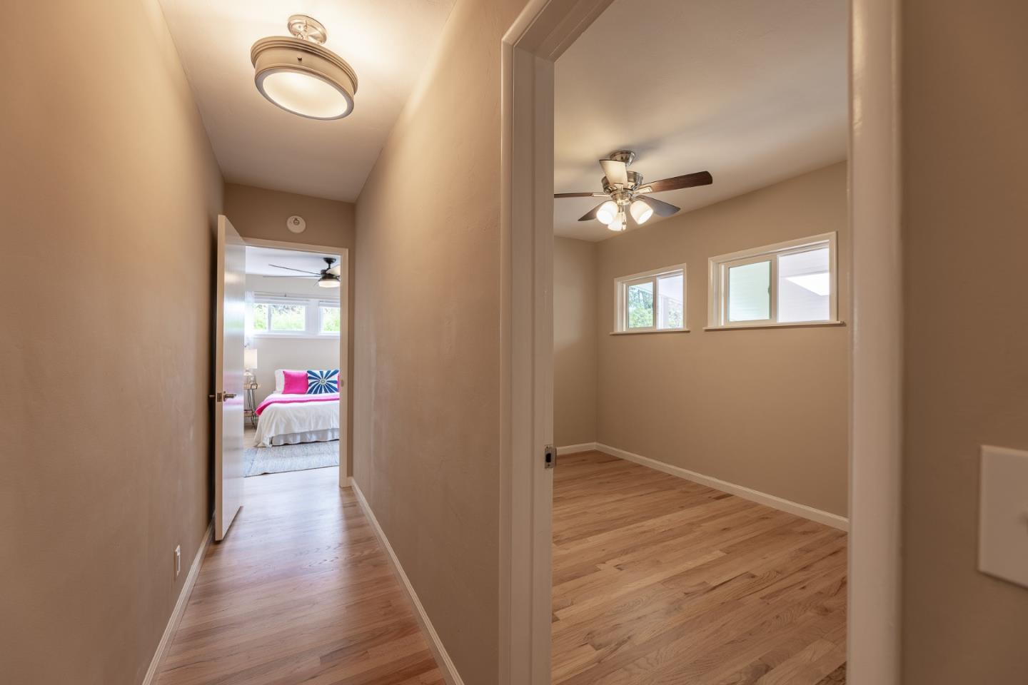 1130 Ripple Avenue Pacific Grove, CA 93950 - Photo 19 of 38 wooden floor in an empty room with a window