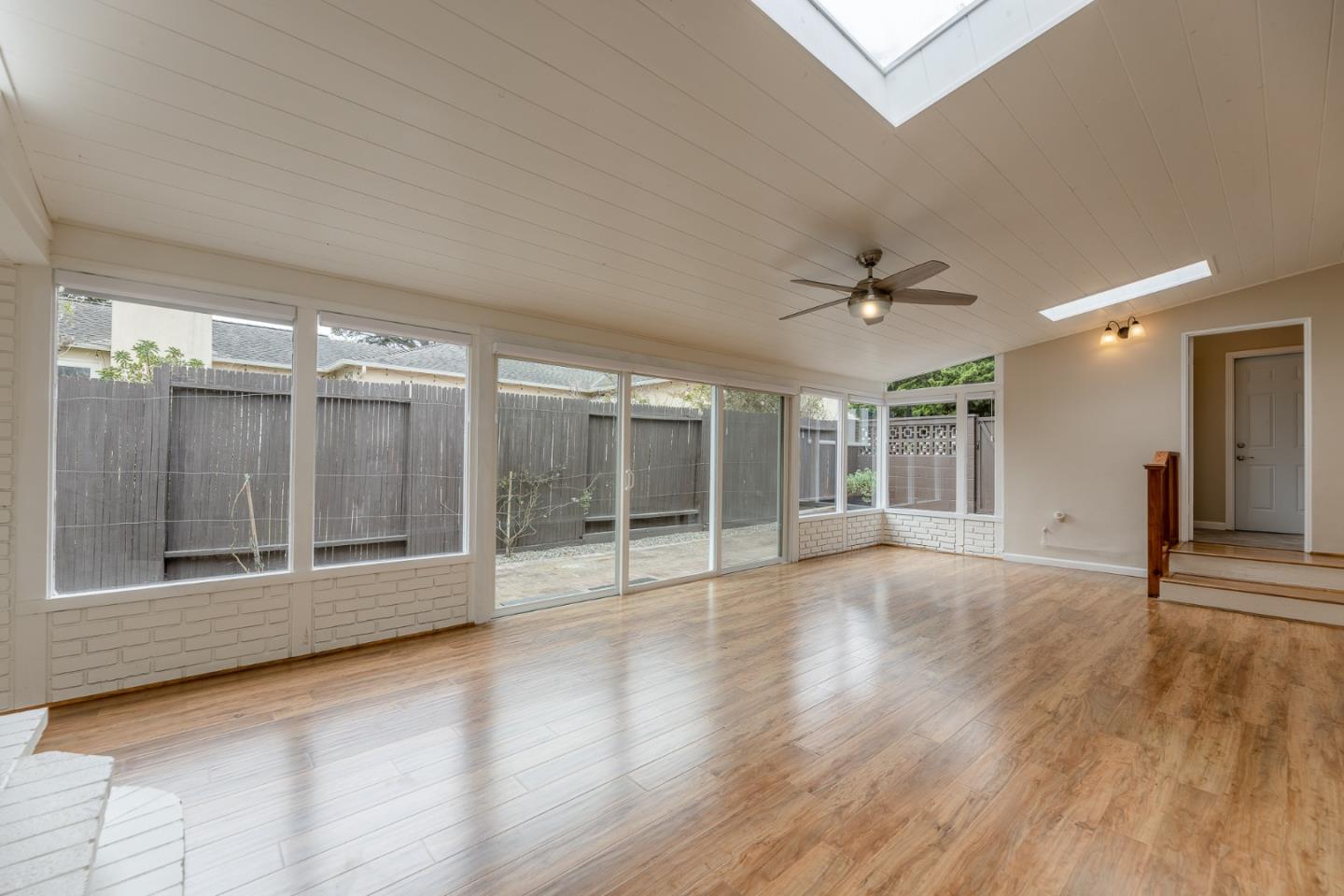 1130 Ripple Avenue Pacific Grove, CA 93950 - Photo 27 of 38 a view of an empty room with wooden floor and a window