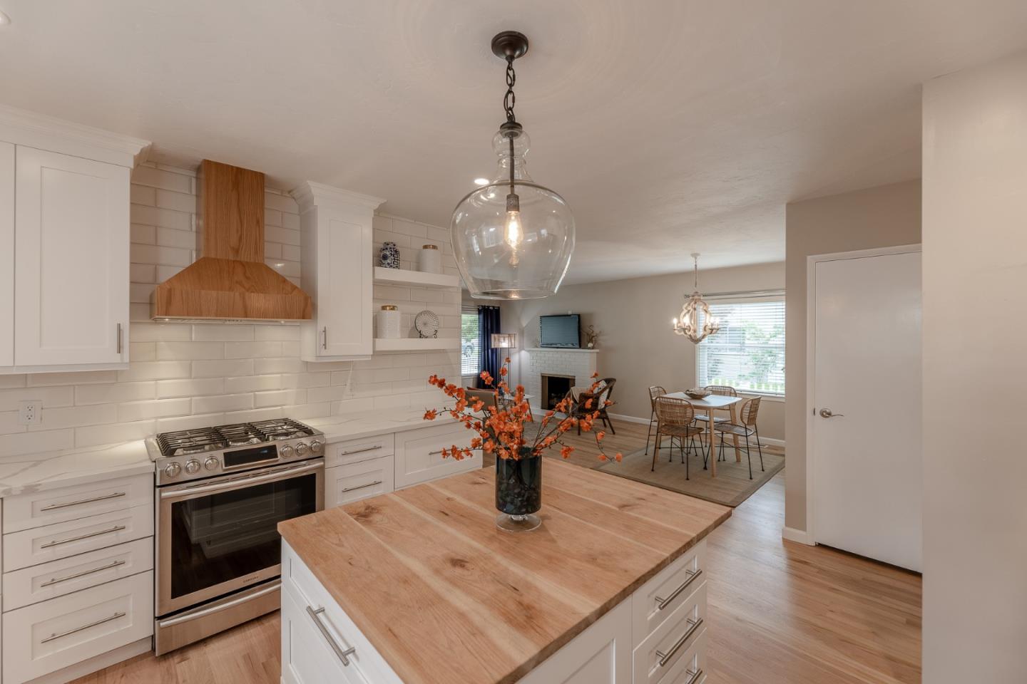 1130 Ripple Avenue Pacific Grove, CA 93950 - Photo 10 of 38 a kitchen with a stove and a wooden floor