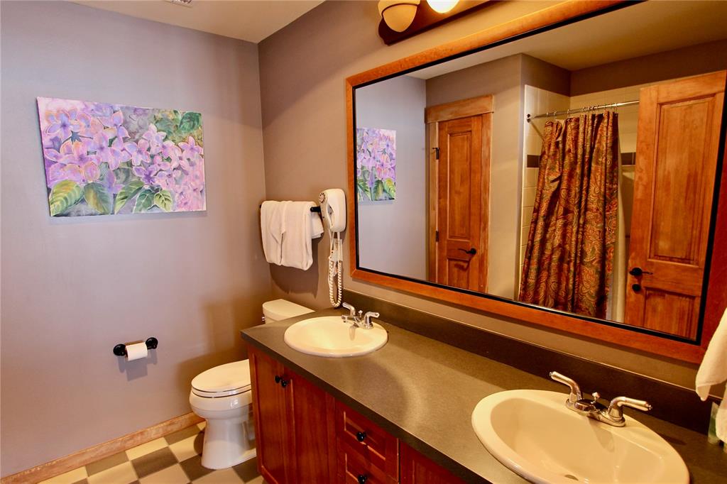 184 Copper Circle, Unit 524 Copper Mountain, CO 80443 - Photo 11 of 19 a bathroom with a sink vanity mirror and toilet